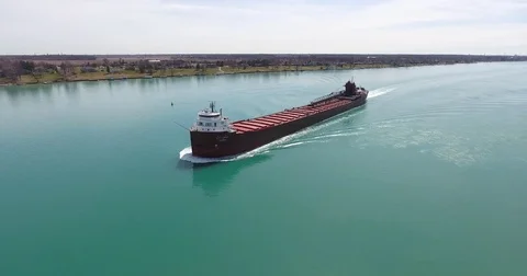 Empty cargo ship sailing in the turquoise sea 库存影片 83695151