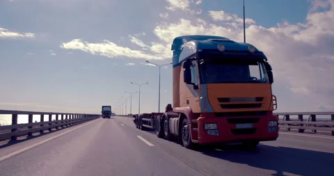 Empty cargo truck, without container, driving on a freeway against the blue sky  Stock Footage 119604231