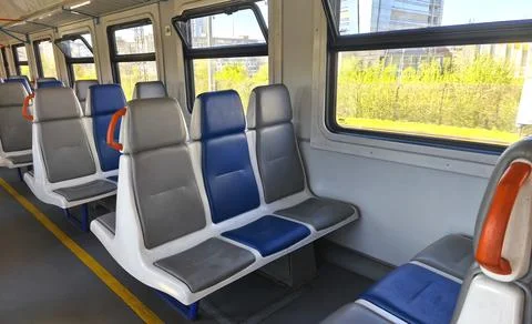 Empty carriage of intercity electric train, trains with blue and gray seats near Stock Photos