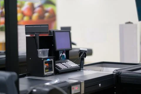 Empty cash desk with computer screen and card payment terminal on blurry ba.. Stock Photos