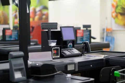 Empty cash desk with computer screen and card payment terminal on blurry ba.. Stock Photos