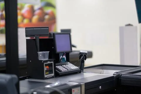 Empty cash desk with computer screen and card payment terminal on blurry ba.. Stock Photos