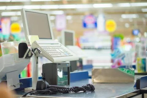 Empty cash desk with computer terminal in supermarket Stock Photos