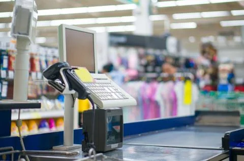 Empty cash desk with computer terminal in supermarket Stock Photos