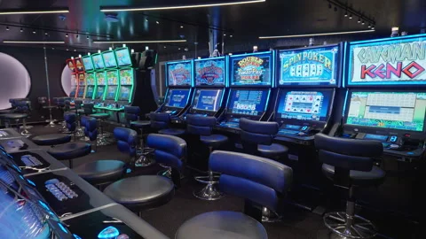Empty casino floor with video poker and slot machines in blue neon lighting. Stock Footage 340186550