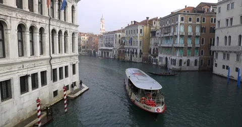 Empty caused by pandemic water bus ferry passing on grand canal near a gondola Stock Footage 150155302