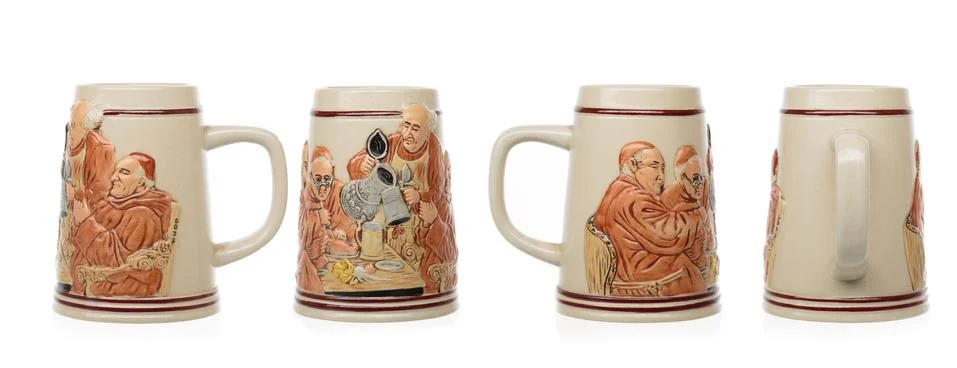 Empty ceramic beer mug with a pattern on a white background. Shot from all si Stock Photos