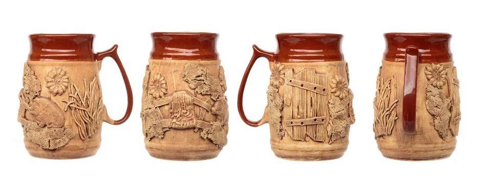 Empty ceramic beer mug with a pattern on a white background. Shot from all si Stock Photos