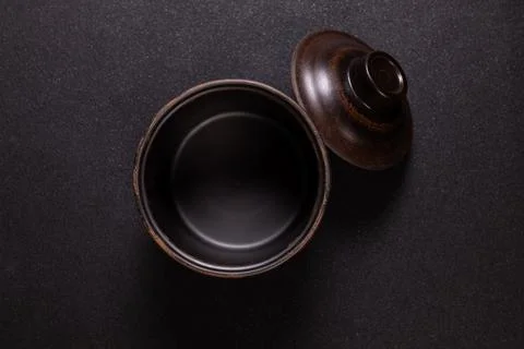 Empty ceramic bowl with lid on dark background Stock Photos