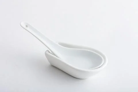 Empty ceramic bowl with spoon Stock Photos