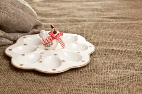 Empty ceramic container for easter eggs on a brown tablecloth Stock Photos