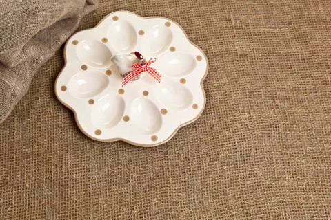 Empty ceramic container for easter eggs on a brown tablecloth Stock Photos