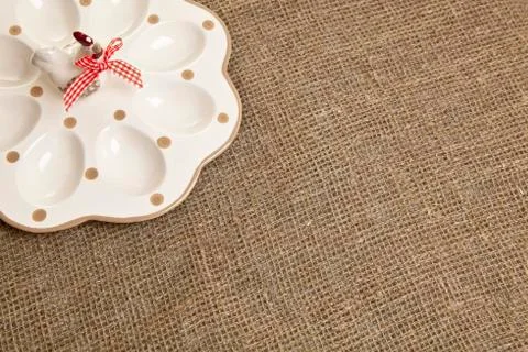 Empty ceramic container for easter eggs on a brown tablecloth Stock Photos