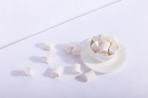 Empty ceramic cup with marshmallows on a saucer, on a white background. Hard  Stock Photos