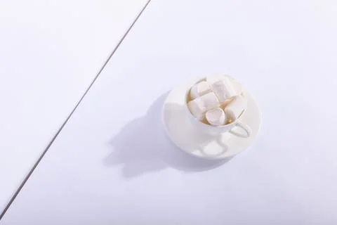 Empty ceramic cup with marshmallows on a saucer, on a white background. Hard  Stock Photos