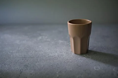 An empty ceramic glass stands on the table. Stock Photos