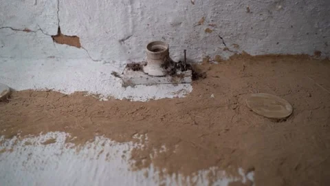 Empty ceramic lamp socket on an old clay wall in a rural house. Removed light Stock Footage 236349794