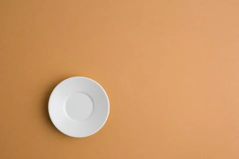 Empty ceramic round plate on brown background with clipping path. Stock Photos