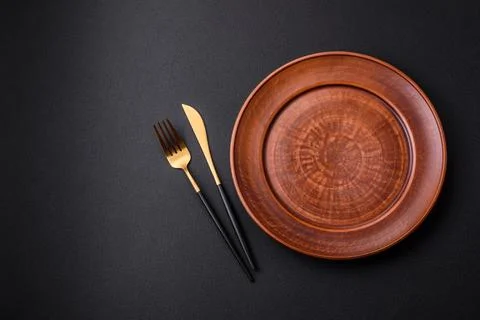Empty ceramic round plate on dark textured concrete background Stock Photos