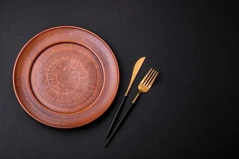 Empty ceramic round plate on dark textured concrete background Stock Photos