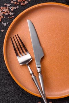 An empty ceramic round plate, kitchen utensils for a dinner table. An empty.. Stock Photos