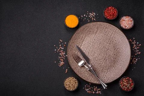 An empty ceramic round plate, kitchen utensils for a dinner table. An empty.. Stock Photos