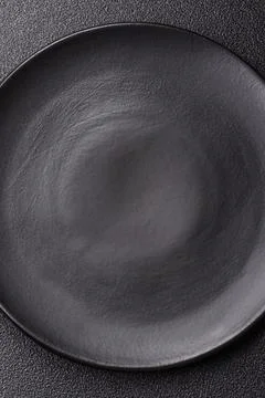 An empty ceramic round plate, kitchen utensils for a dinner table. An empty.. Stock Photos