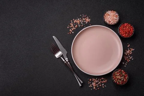 An empty ceramic round plate, kitchen utensils for a dinner table. An empty.. Stock Photos