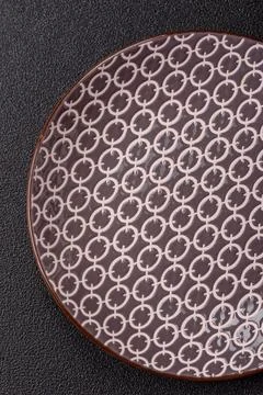 An empty ceramic round plate, kitchen utensils for a dinner table. An empty.. Stock Photos