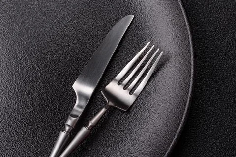 An empty ceramic round plate, kitchen utensils for a dinner table. An empty.. Stock Photos