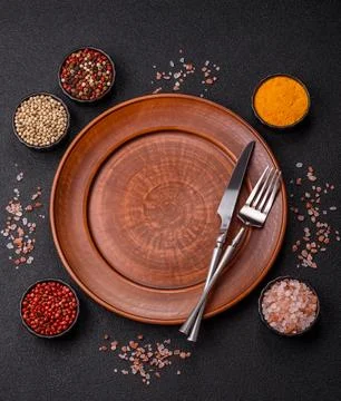 An empty ceramic round plate, kitchen utensils for a dinner table. An empty.. Stock Photos