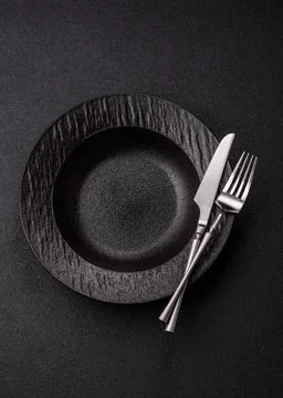 An empty ceramic round plate, kitchen utensils for a dinner table. An empty.. Stock Photos