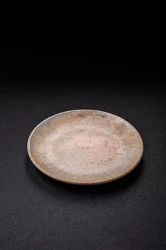 An empty ceramic round plate, kitchen utensils for a dinner table. An empty.. Stock Photos