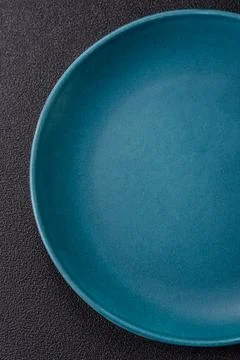 An empty ceramic round plate, kitchen utensils for a dinner table. An empty.. Stock Photos