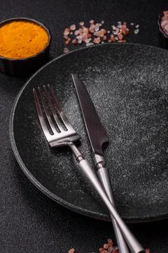 An empty ceramic round plate, kitchen utensils for a dinner table. An empty.. Stock Photos