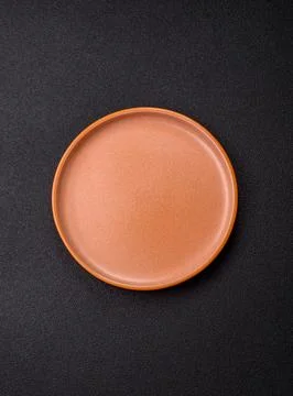 An empty ceramic round plate, kitchen utensils for a dinner table. An empty.. Stock Photos