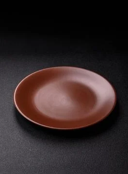 An empty ceramic round plate, kitchen utensils for a dinner table. An empty.. Stock Photos