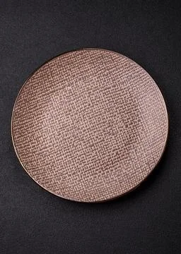 An empty ceramic round plate, kitchen utensils for a dinner table. An empty.. Stock Photos
