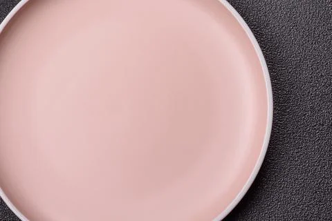 An empty ceramic round plate, kitchen utensils for a dinner table. An empty.. Stock Photos