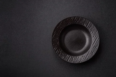 An empty ceramic round plate, kitchen utensils for a dinner table. An empty.. Stock Photos