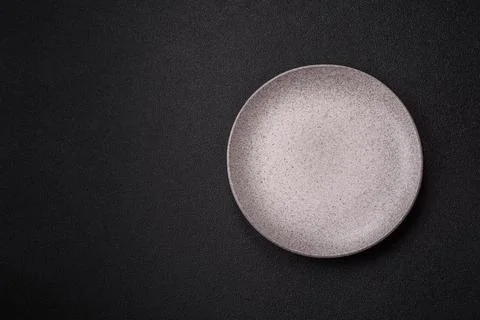 An empty ceramic round plate, kitchen utensils for a dinner table. An empty.. Stock Photos