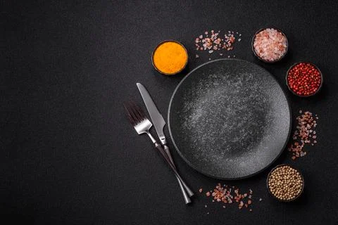 An empty ceramic round plate, kitchen utensils for a dinner table. An empty.. Stock Photos