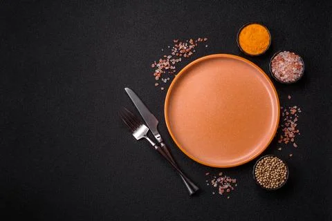 An empty ceramic round plate, kitchen utensils for a dinner table. An empty.. Stock Photos