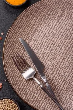 An empty ceramic round plate, kitchen utensils for a dinner table. An empty.. Stock Photos