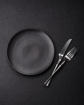 An empty ceramic round plate, kitchen utensils for a dinner table. An empty.. Stock Photos