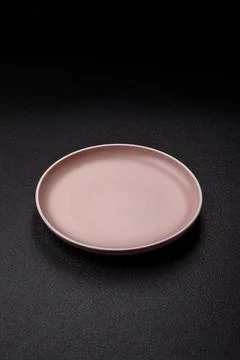 An empty ceramic round plate, kitchen utensils for a dinner table. An empty.. Stock Photos