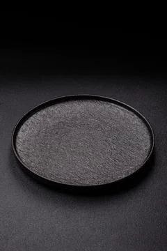 An empty ceramic round plate, kitchen utensils for a dinner table. An empty.. Stock Photos