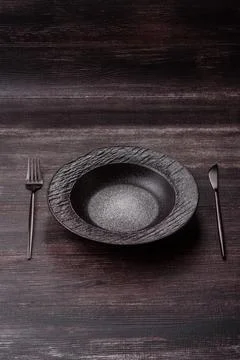 An empty ceramic round plate, kitchen utensils for a dinner table. An empty.. Stock Photos