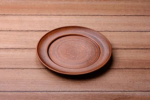 An empty ceramic round plate, kitchen utensils for a dinner table. An empty.. Stock Photos