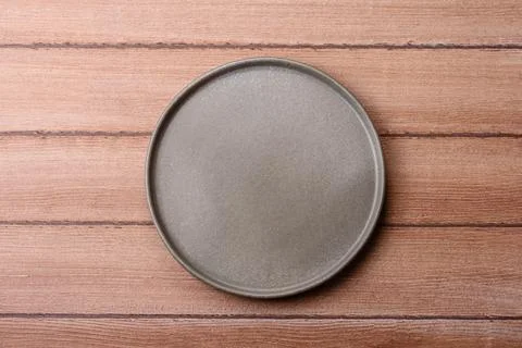 An empty ceramic round plate, kitchen utensils for a dinner table. An empty.. Stock Photos